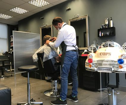 A barber at work in The Cut